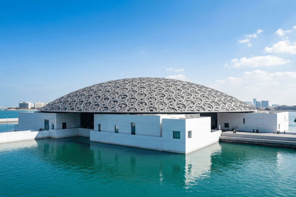 Aerial drone view of Louvre Abu Dhabi surrounded by turquoise water